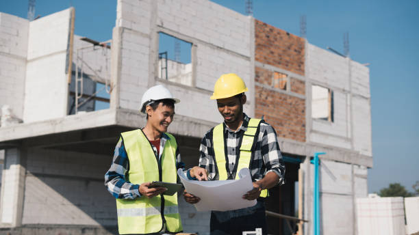 istock Structural engineer and architect working with blueprints discuss at the outdoors construction site. 1456824177