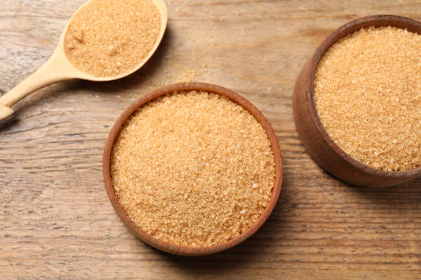 istock Different dishes with brown sugar on wooden table, flat lay 1456825039