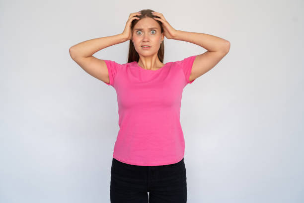 istock Frustrated young woman with hands on head 1456825426