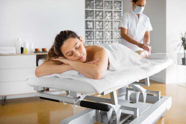 istock Beautiful woman lying down relaxing in spa salon 1456827312