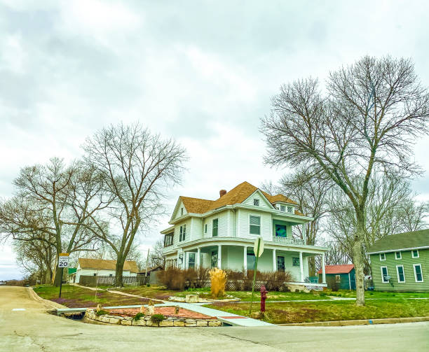 March 30, 2022, Manhattan, Kansas. Beautiful homes can be seen from the street in Manhattan, Kansas.  These homes show the variety of styles in this area. These homes have weathered the winter and will begin to show more of their beauty as the season continues to turn into spring.