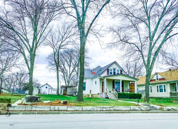 March 30, 2022, Manhattan, Kansas. Beautiful homes can be seen from the street in Manhattan, Kansas.  These homes show the variety of styles in this area. These homes have weathered the winter and will begin to show more of their beauty as the season continues to turn into spring.
