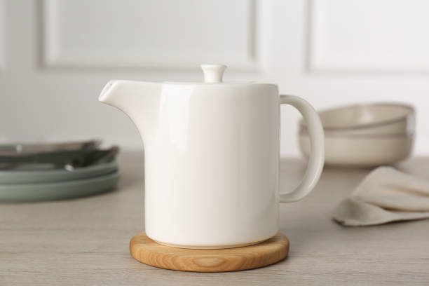 istock Ceramic teapot on wooden table. Clean dishware 1456831562