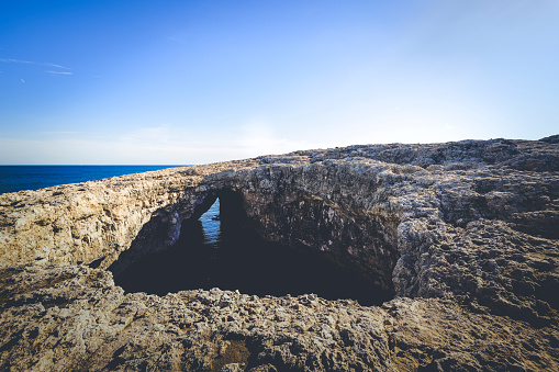 coral lagoon hole. huge hole in the coral rocks at the northern coastline in malta island, europe.