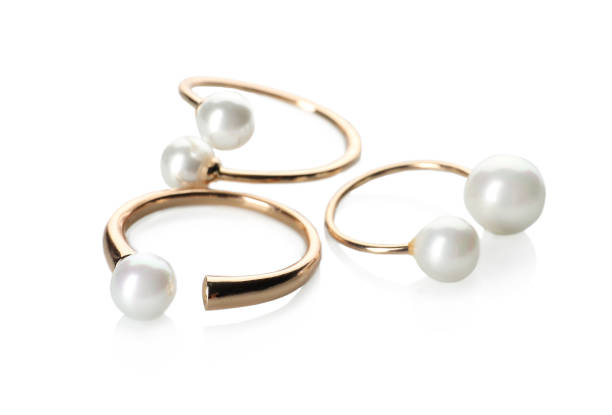 istock Elegant golden rings with pearls on white background 1456832034
