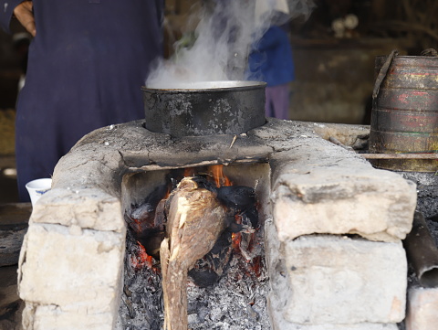 Tea is being made over a wood fire at a local tea stall (Dhaba).