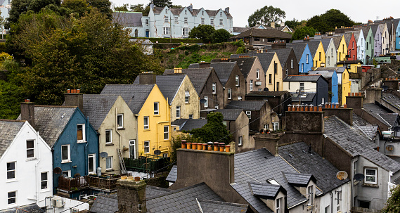 A row of colorful houses on a steep hill near the waterfront in Cobh.