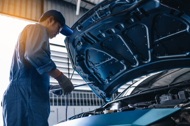 istock Maintenance worker checking tire service via insurance system at garage, Safety vehicle to reduce accidents before a long travel, road trip transportation. 1456834954
