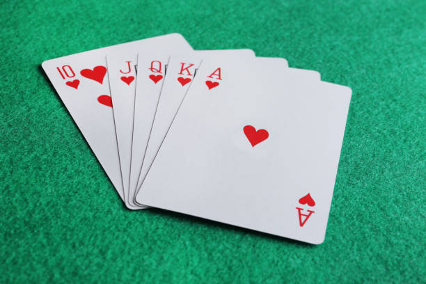 istock Playing cards with royal flush combination on green table 1456835496