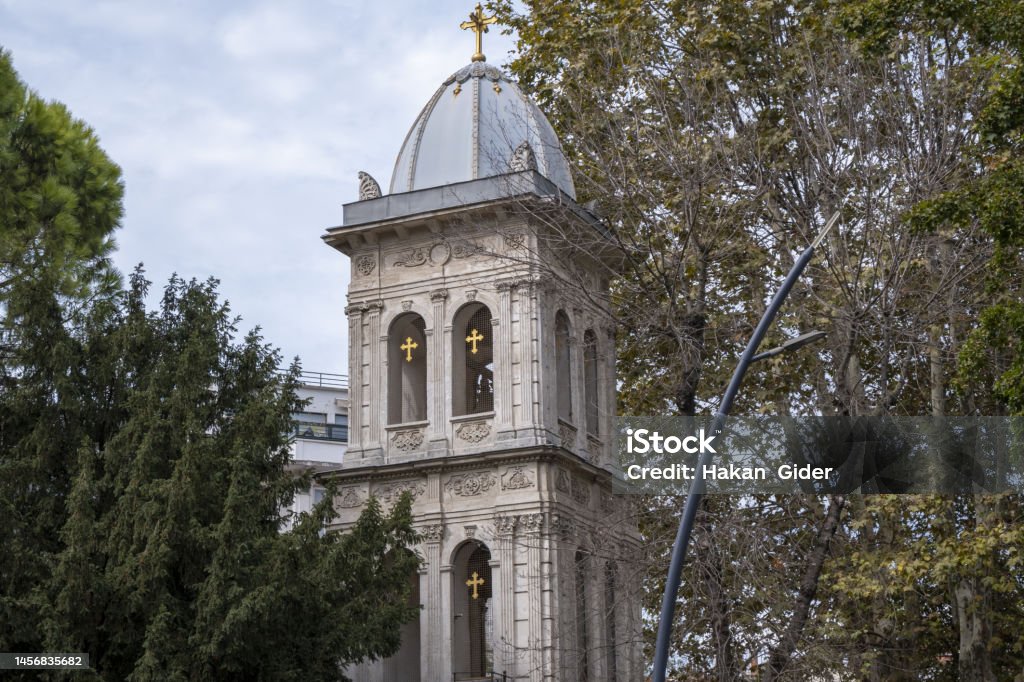 church tower tower among trees, cloudy weather, old church in Istanbul Turkey, close up detailed Church of Ayios Yeorgios Church of Ayios Yeorgios Kuzguncuk Uskudar Ancient Stock Photo