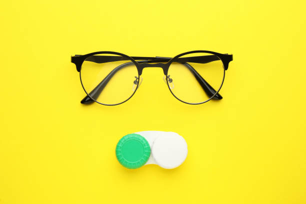 istock Case with contact lenses and glasses on yellow background, flat lay 1456836389
