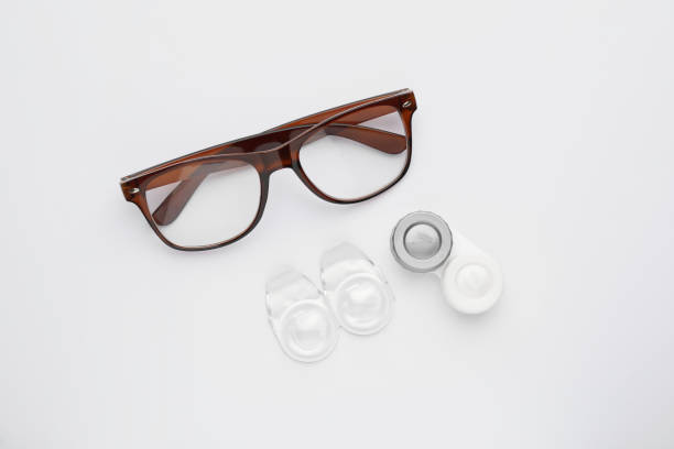 istock Packages with contact lenses, case and glasses on white background, flat lay 1456836611