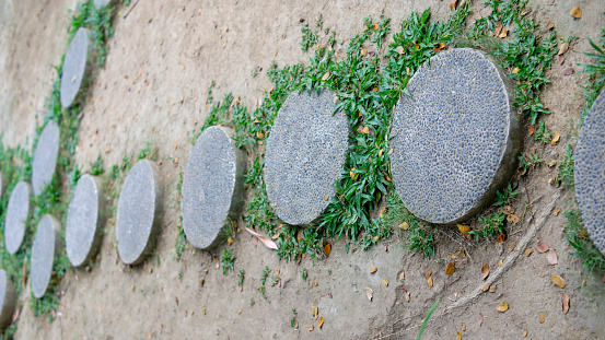 round stone ornaments used for footings to avoid trampling grass.