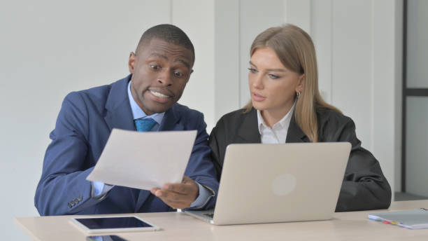 istock African Businessman Arguing with Businesswoman, Problems 1456849288