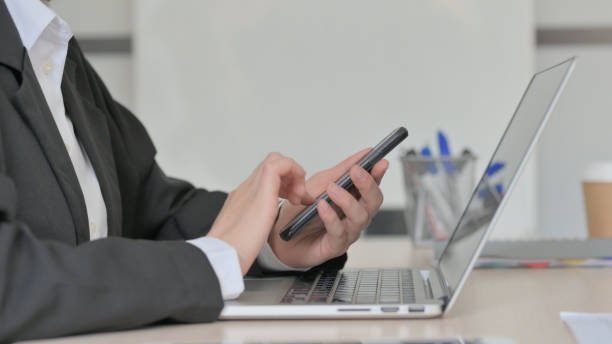 istock Young Businesswoman Using Smartphone, Close Up 1456849355