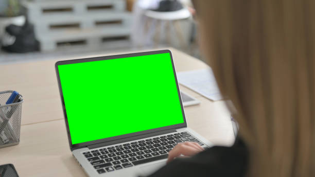 istock Young Businesswoman Working on Laptop with Chroma Key Screen 1456849579