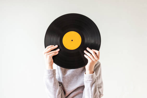 istock Child holding vinyl record in front of her face 1456851803