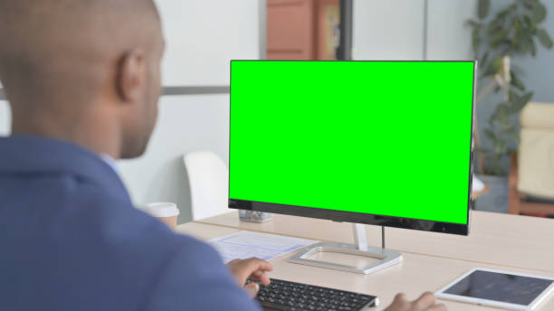 istock Young African Businessman using Desktop with Green Screen 1456851867