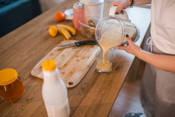 istock An unrecognizable athlete woman pours a smoothie from a blender into a drinking glass 1456852169