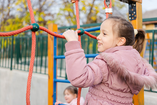 Portrait of a girl student a having fun on playground at school