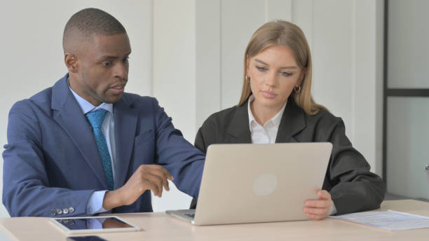 istock Young Business People Discussing Work on Laptop 1456853371