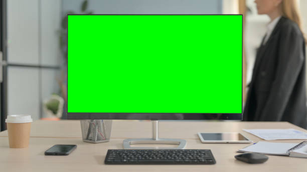 istock Desktop with Green Screen on Desk in Office 1456853964
