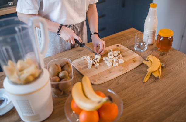 istock An unrecognizable female athlete chops a banana on a cutting board in the kitchen 1456854273