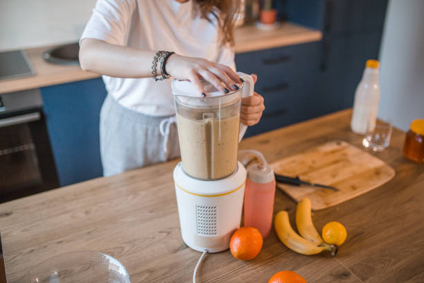 istock Unrecognizable woman uses a blender to make a healthy smoothie 1456854777