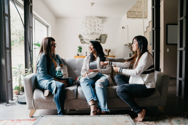 istock Three friends talking together at home 1456855019