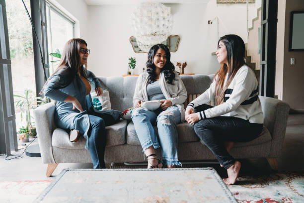 istock Three friends talking together at home 1456855021