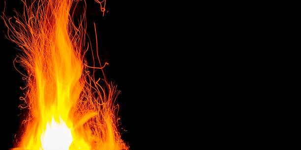 Fire embers particles over black background. Fire sparks background. Abstract dark glitter fire particles lights.