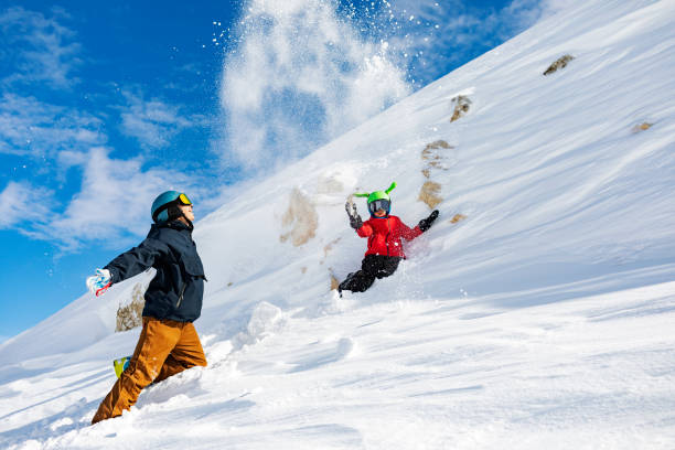 istock Father and son having fun at ski resort, playing with snow 1456857387