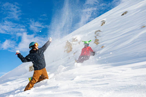istock Father and son having fun at ski resort, playing with snow 1456857710