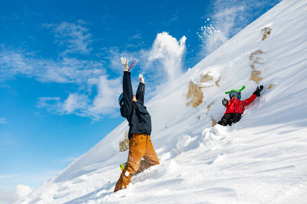 istock Father and son having fun at ski resort, playing with snow 1456857729