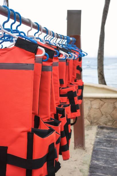 istock Life jackets dry on hangers at a beach, selective focus. 1456858341