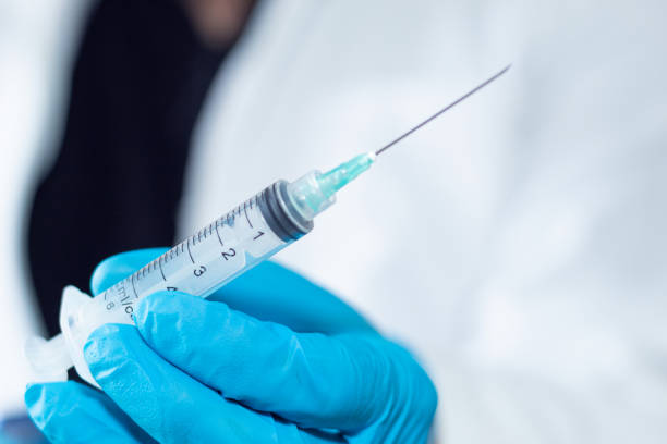 istock Unrecognizable doctor holding an empty syringe with a needle 1456858468