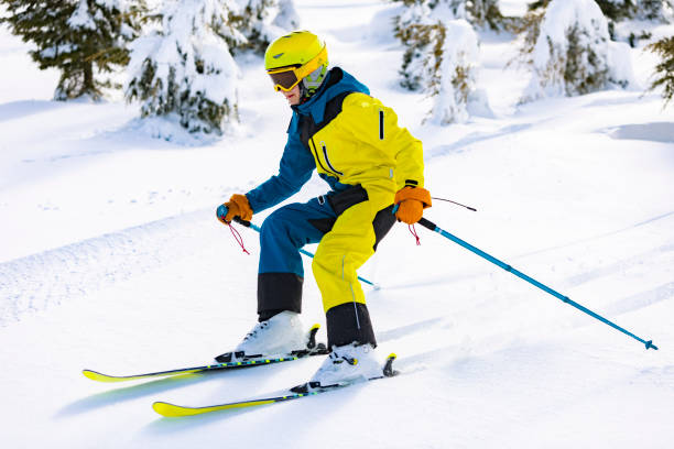istock Boy skiing in mountains in fir trees 1456858510