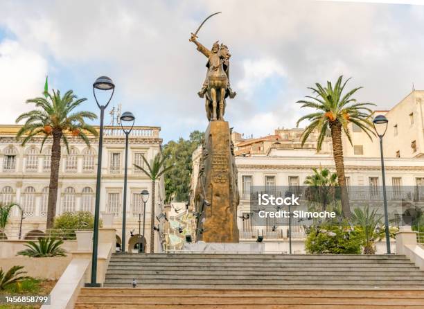 El Amir Abdelkader Statue With Flying Pigeons And Palm Trees Stock Photo - Download Image Now