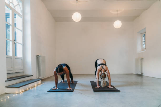 istock Two women are practicing yoga together 1456859269