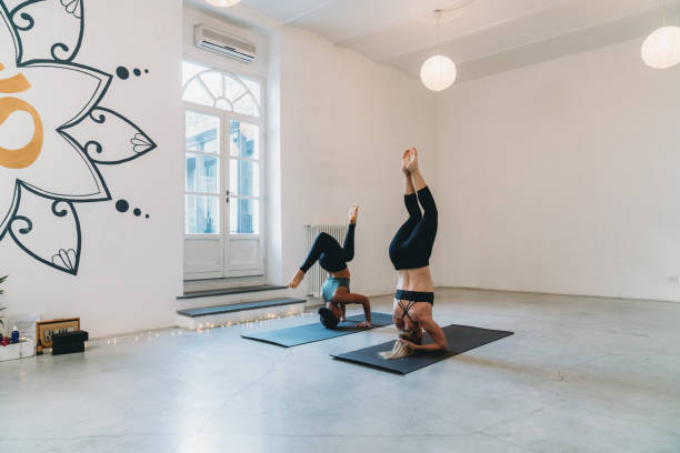 Two women are practicing yoga together