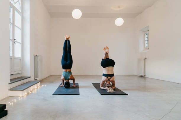Two women are practicing yoga together