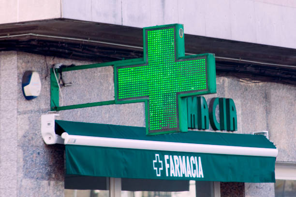 istock Pharmacy sign in spanish language, awning  and green cross 1456860712