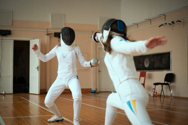 Girls fencers training in the fencing hall Fencing sports fencing sport stock pictures, royalty-free photos & images