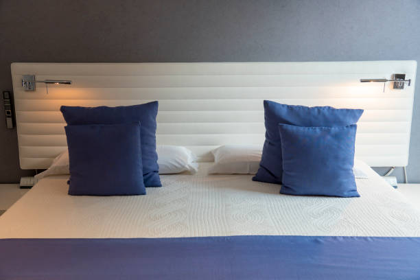istock White pillow and blue pillow on bed and with blanket in modern bedroom 1456863926