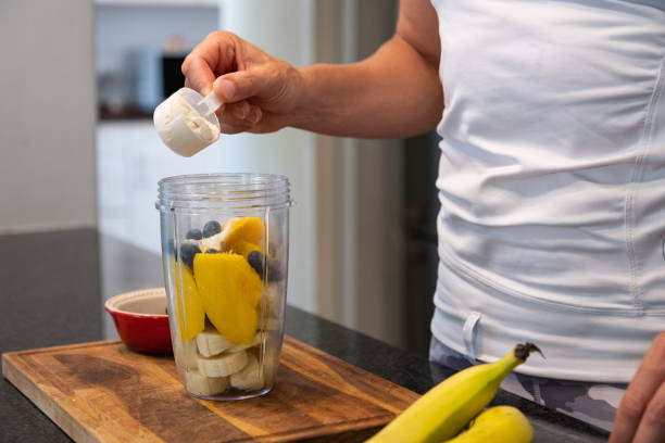 istock Fit woman makes a healthy fruit smoothie to drink 1456864861