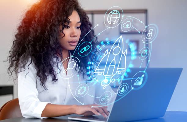 istock African businesswoman using laptop, startup rocket hologram with helpdesk 1456866649