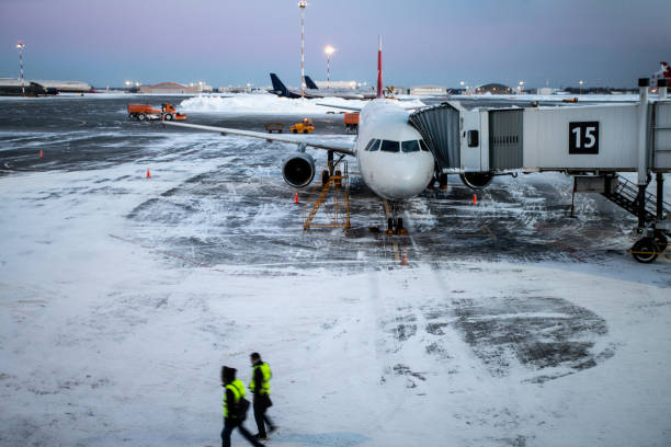 istock Passenger airplane on the airfield docked with passenger boarding bridge 1456867174