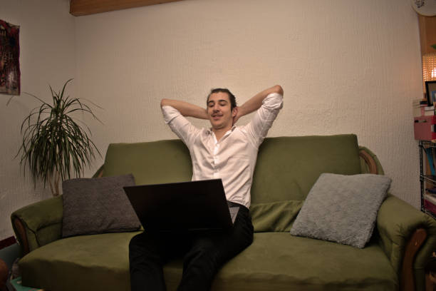 istock Young entrepreneur in white shirt on a green sofa 1456867831