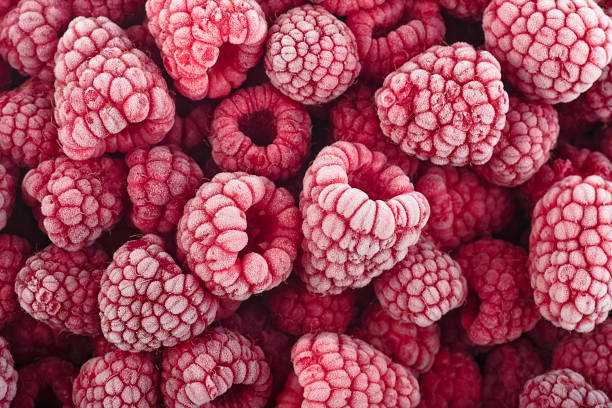 istock Frozen raspberries covered with hoarfrost, top view. Berries background. Summer berries. 1456869271