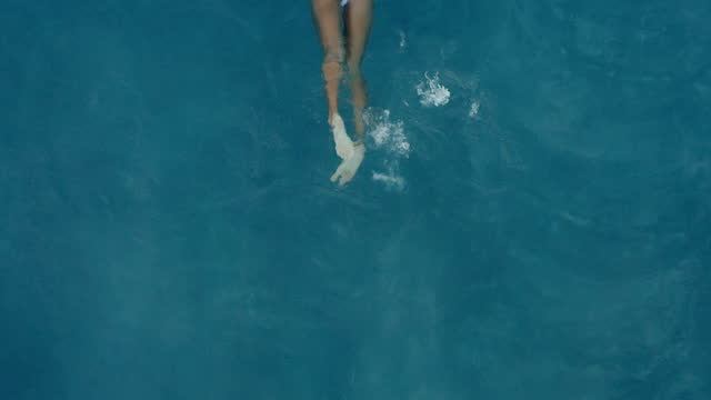 Woman Swimming in Luxury Pool